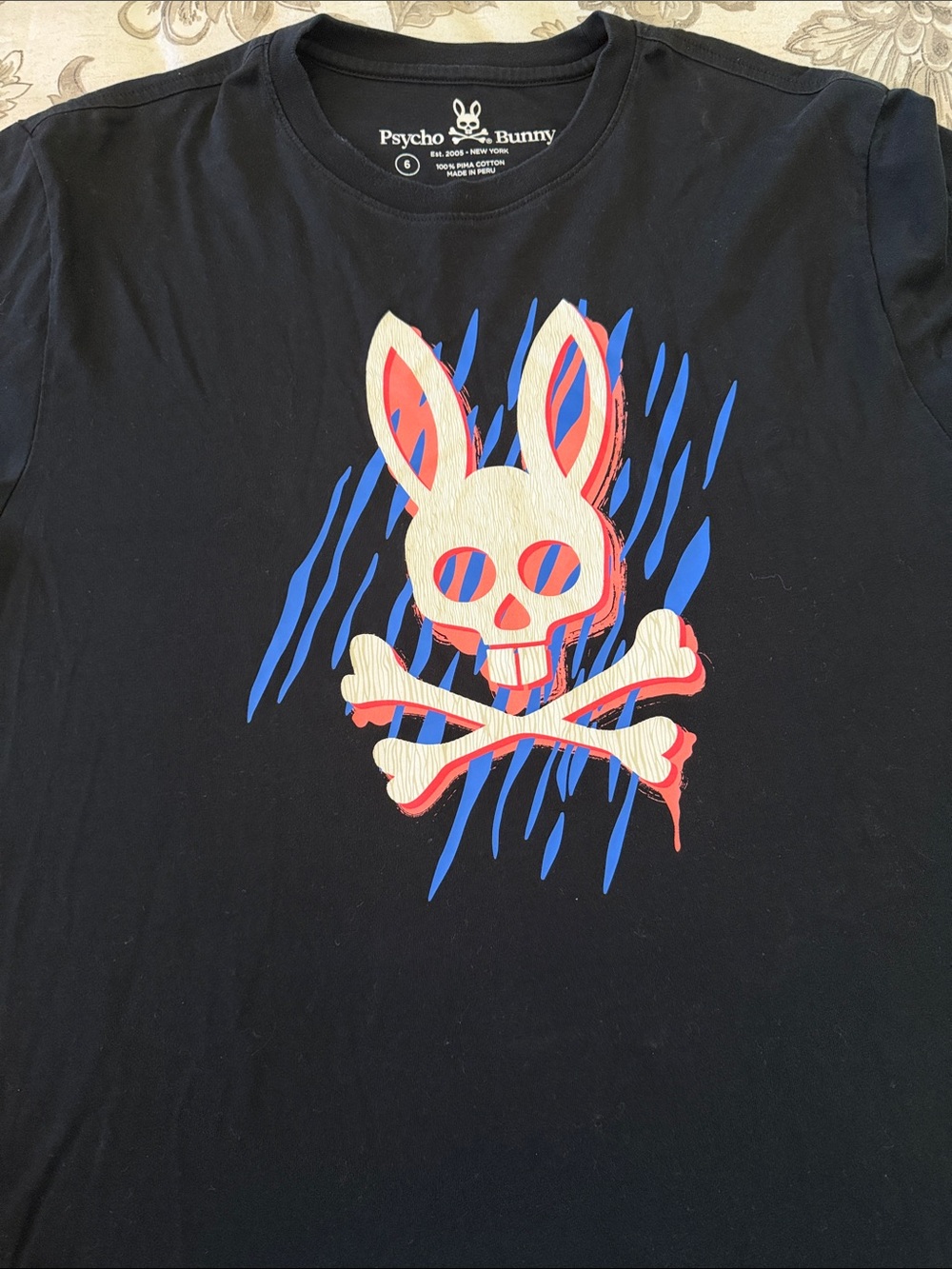 Psycho Bunny Black Tee with Cream, Blue & Red Graphic